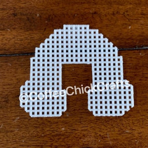 May include: White plastic canvas shaped like an arch, with the text "@CoffeeChickCrafts" printed on it.