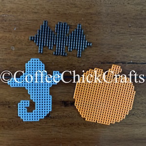 May include: Three Halloween-themed crafts made with plastic canvas. A blue seahorse, an orange pumpkin, and a black bat.
