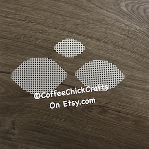 May include: Three white plastic canvas shapes, two are oval and one is diamond shaped. The canvas is for cross stitch or other needle crafts. The text "©CoffeeChickCrafts On Etsy.com" is visible in the image.