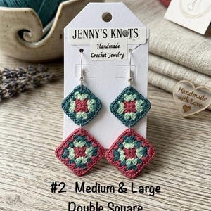 May include: Handmade crochet earrings in a double square design. The earrings feature a teal, red, and light green color scheme. The text on the tag reads "JENNY'S KNOTS Handmade Crochet Jewelry" and "#2- Medium & Large Double Square."