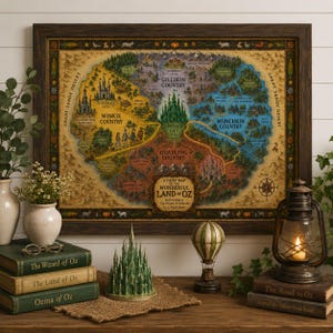 May include: A framed map of the Land of Oz featuring four colored regions, the Emerald City, and text reading A Fairy Map of the Wonderful Land of Oz. The map is displayed with a green castle figurine, a hot air balloon model, and books.
