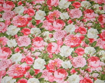 May include: A fabric with a dense floral pattern featuring roses in shades of red, pink, and white, interspersed with green leaves. The roses vary in size and are closely arranged, creating a full, textured appearance.