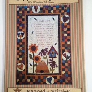 May include: A colourful quilt pattern featuring a beehive, sunflowers, and a birdhouse. The quilt is surrounded by a border of red, white, and blue squares. The title "House Rules" is written in a brown font at the top of the quilt. The text below the title reads "If you sleep on it... make it up. If you turn it on... turn it off. If you wear it... hang it up. If you empty it... fill it up. If you spill it... wipe it up. If you drop it... pick it up. If you open it... close it. If you break it... fix it. If it rings... answer it. If it howls... feed it. If it cries... love it."