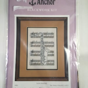 May include: Anchor Blackwork Kit embroidery pattern for a saxophone on a musical staff. The kit includes 27 count white Evenweave fabric, Anchor Stranded Cotton, a chart, full instructions, and a needle. Size: 6 inches by 4 1/2 inches.