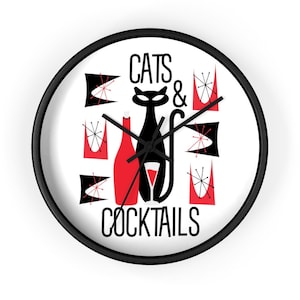 May include: A black and white clock with a red and black design. The clock features a black cat, a red bottle, and red glasses. The text "Cats & Cocktails" is printed on the clock.