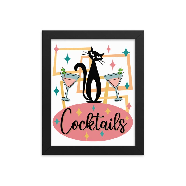 May include: A framed print with a retro design featuring a black cat sitting between two martini glasses with olives. The text "Cocktails" is written in a pink oval.