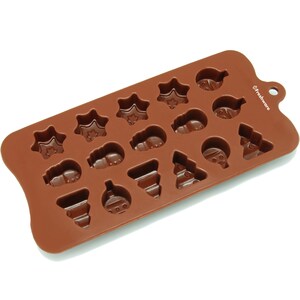 May include: Brown silicone mold with 16 cavities shaped like Christmas ornaments, stars, and trees. The mold is labeled "Freshware".