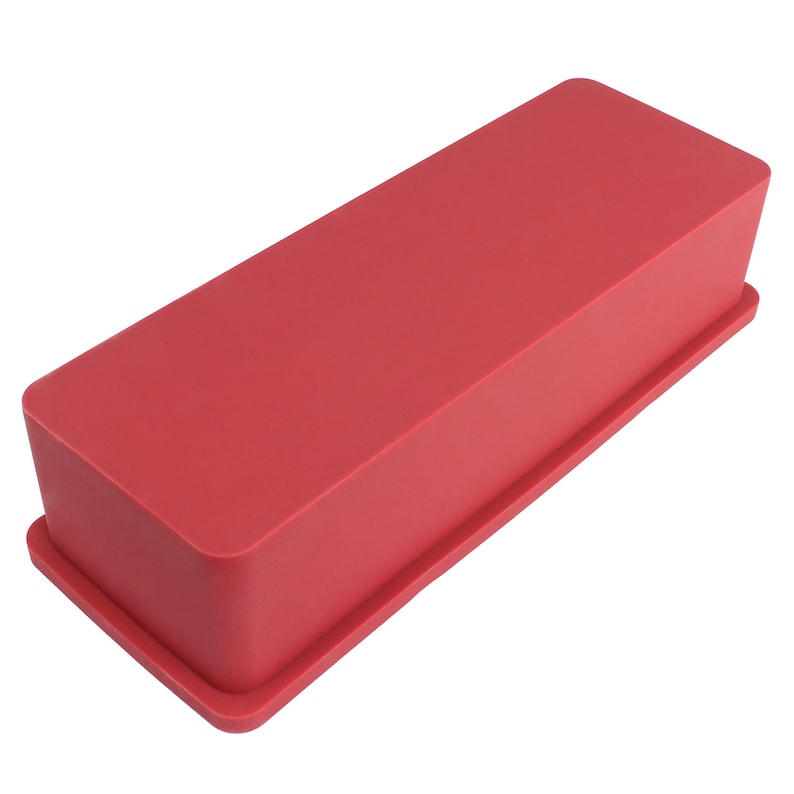 May include: A red silicone baking mould in the shape of a loaf of bread.