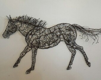 May include: A black wire sculpture of a horse running. The horse is made of thin wire that is twisted and woven together to create a detailed and realistic depiction of the animal.