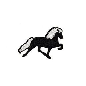 May include: Black and white embroidered patch of a horse running. The horse has a white mane and tail.