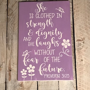 She is clothed in strength and dignity wood sign