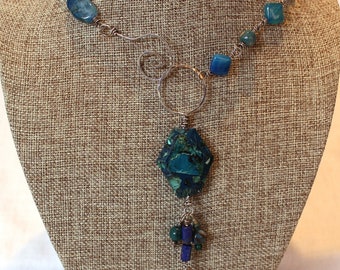 Silver Y-necklace w/ front clasp on a wire linked chain of sterling beads and a variety of blue matrix agate, lapis and apatite beads