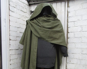 May include: A long, olive green hooded cloak draped over a dark gray long-sleeved garment. The cloak features a deep hood and falls in loose, flowing folds around the torso, covering the upper portion of the dark gray base layer underneath.