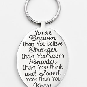 May include: Silver oval keychain with the engraved message: "You are Braver than You believe Stronger than You seem Smarter than You think and Loved more than You Know"