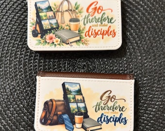 May include: Two rectangular card holders with brown edges and white fronts. Each features a printed illustration of a display stand, a bag, a coffee cup, a book, and the text Go therefore and make disciples in colorful script.