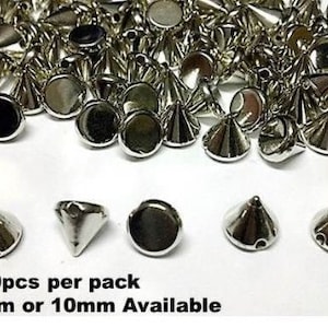 May include: A collection of shiny silver metal cone-shaped studs with flat backs. The image shows a close-up of the studs, with some arranged in a pile and others displayed in a row. Text at the bottom reads "100pcs per pack 8mm or 10mm Available."