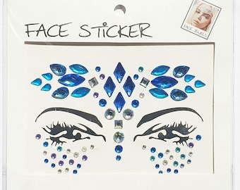 May include: Blue and silver face jewels sticker sheet. The sheet features a design with two eyes, a forehead, and a nose. The jewels are in various shapes and sizes.