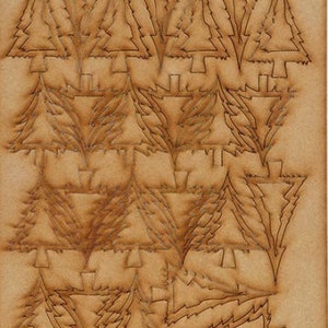 May include: A sheet of brown craft paper with a repeating pattern of Christmas trees cut out. The text "Oh, Christmas Tree" is printed at the bottom of the sheet.