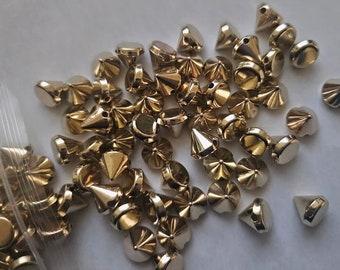 CraftbuddyUS 100pcs Acrylic 10mm Gold Sew On Cone Spike Studs, DIY