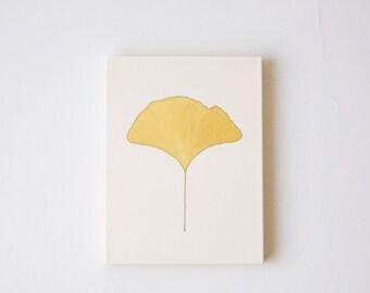 May include: A yellow ginkgo leaf illustration on a white background.