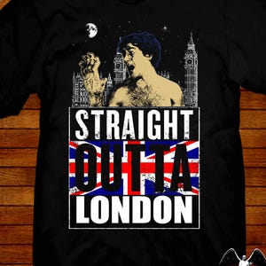 Puede incluir: Camiseta negra con un diseño gráfico que muestra a un hombre, el Big Ben y el texto "STRAIGHT OUTTA LONDON" sobre una bandera de la Union Jack. Incluye la firma del artista.