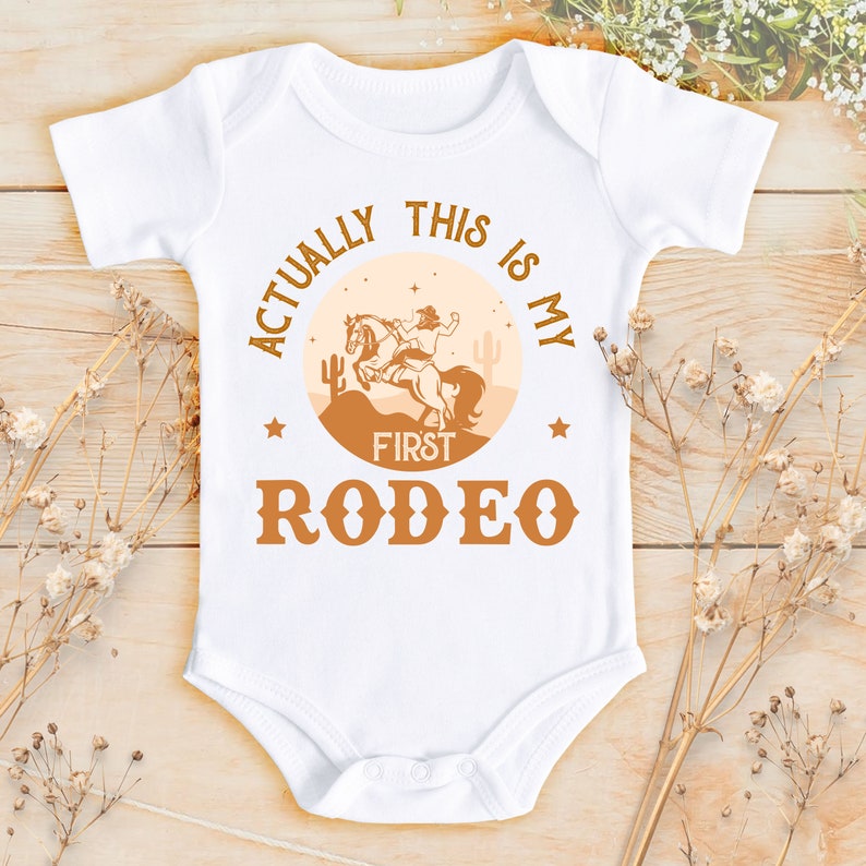 Actually This Is My First Rodeo Bodysuit Cute Cowboy & Cowgirl Pregnancy Announcement Shirt horse Rodeo Gift Yeehaw Tee 839 Bodysuit | Short Sleeve | White