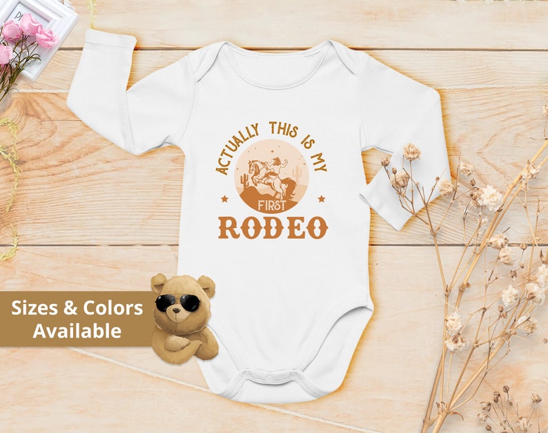 Actually This Is My First Rodeo Bodysuit Cute Cowboy & Cowgirl Pregnancy Announcement Shirt horse Rodeo Gift Yeehaw Tee 839 Bodysuit | Long Sleeve | White