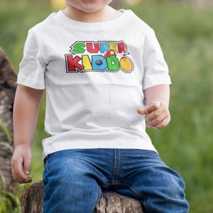 Super Kiddo T-shirt, Father Son Daughter Retro Game Gift, Super Kiddo Gaming Shirt, Gamer Funny Kids Birthday Shirt, Dad Children Gift, 357
