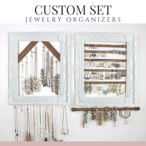 May include: Two white framed jewelry organizers with various necklaces and earrings. The frames have a distressed look and are mounted on a white wall. The top text reads "CUSTOM SET JEWELRY ORGANIZERS".