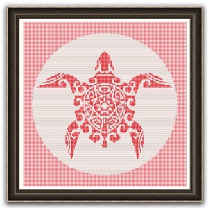 May include: Framed cross-stitch art featuring a red turtle design. The turtle is centered on a white circle, set against a pink and white gingham background. The artwork is enclosed in a dark brown frame.