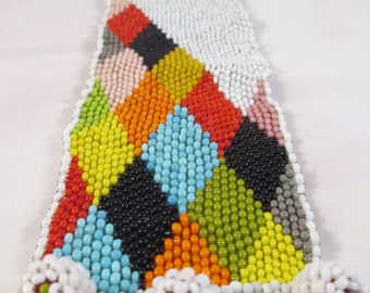Harlequin pattern beaded wrist cuff with three ball and loop closures, made with vintage seed beads, peyote stitch bracelet