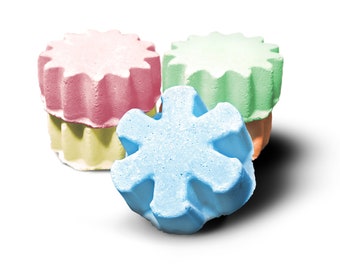 May include: Three bath bombs in the shape of stars and a snowflake. The bath bombs are pink, green, and blue.