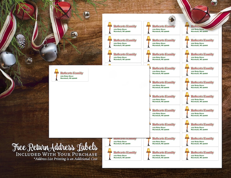 May include: Sheets of return address labels with a Christmas theme. Each label features a lamp graphic and the text "Roberts Family, 123 Main Store, Marshall, MI 49068." The image includes holiday decorations and the text "Free Return Address Labels Included With Your Purchase."