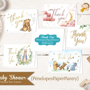 May include: Set of five baby shower thank you cards featuring Winnie the Pooh and other characters. The cards are white with gold lettering and illustrations. The text on the cards reads "Thank You!" and "PenelopesPaperPantry".