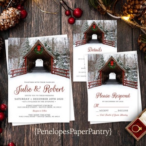 May include: A winter wedding invitation with a red covered bridge and a wreath of greenery on the front. The invitation is for Julie and Robert and includes the date, time, and location of the wedding. The invitation also includes a RSVP card with a red covered bridge and a wreath of greenery on the front.