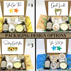 May include: Four cardboard gift boxes containing self-care items including a spray bottle, a bath bomb, a candle in a tin, and a roller bottle. Each box lid features a unique message: You Got This, Good Luck, Sending Good Vibes, and You Did It.