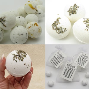 May include: White bath bombs with dried lavender and orange flowers. The bath bombs are packaged in white organza bags with a label that reads "Self Care by Jo Success".