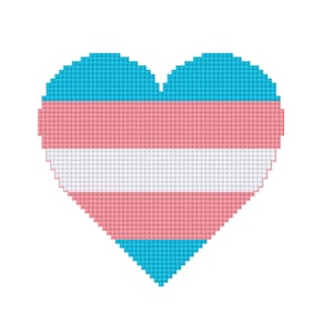 May include: A pixelated heart design in the colors of the transgender flag: light blue, pink, and white. The heart shape is composed of small, square pixels, creating a textured appearance. The design is set against a plain white background.