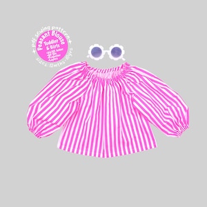 May include: A bright pink and white vertical striped peasant blouse with long, voluminous sleeves and an elasticized neckline, accompanied by white flower-shaped sunglasses. Text reads: pdf sewing pattern Peasant Blouse Toddler & Girls.