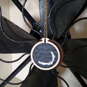 Negative Bat - miniature embroidery hoop necklace with wax detail