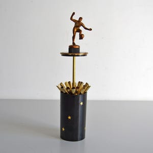 Vintage cigarette dispenser, football player and stars