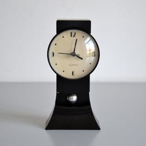 Vintage black pendulum 80s desk clock in working condition