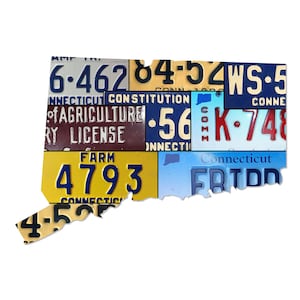 May include: A colorful mosaic of vintage license plates shaped like the state of Connecticut. The plates feature various numbers, letters, and phrases, including "Connecticut Constitution", "Agriculture", "Farm", and "WS-5".