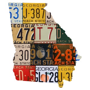 May include: A collage of vintage Georgia license plates in the shape of the state of Georgia. The plates feature peach designs and the text "Peach State".