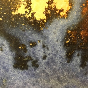 May include: Abstract watercolor painting with a blue background and splashes of yellow, orange, and black paint.