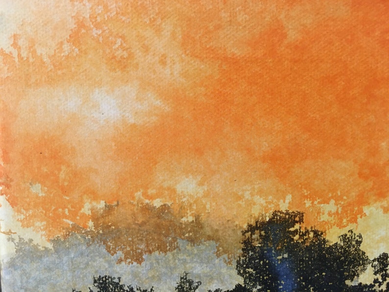 May include: A watercolor painting of a sunset with orange, yellow, and brown hues. The sky is a vibrant orange, with clouds that are a lighter shade of orange and yellow. The bottom of the painting is a darker brown, with hints of gray.