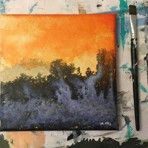 May include: A watercolor painting on canvas depicting a sunset over a forest. The sky is a vibrant orange and yellow, with wispy clouds. The trees are silhouetted against the sky, and the foreground is a dark blue and purple.