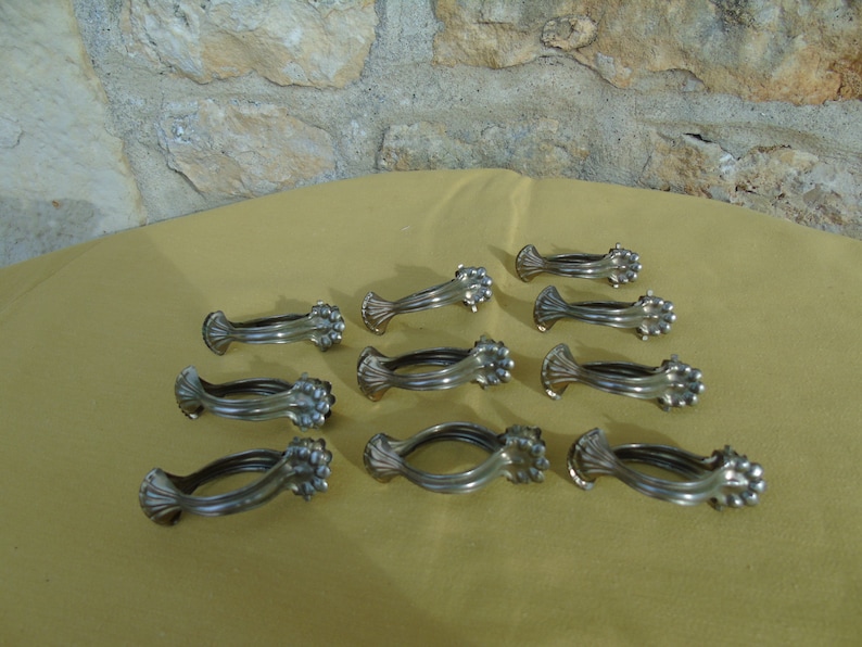 1219 French antique large size set of 10 ormolu pressed bronze curtain rings with clips.