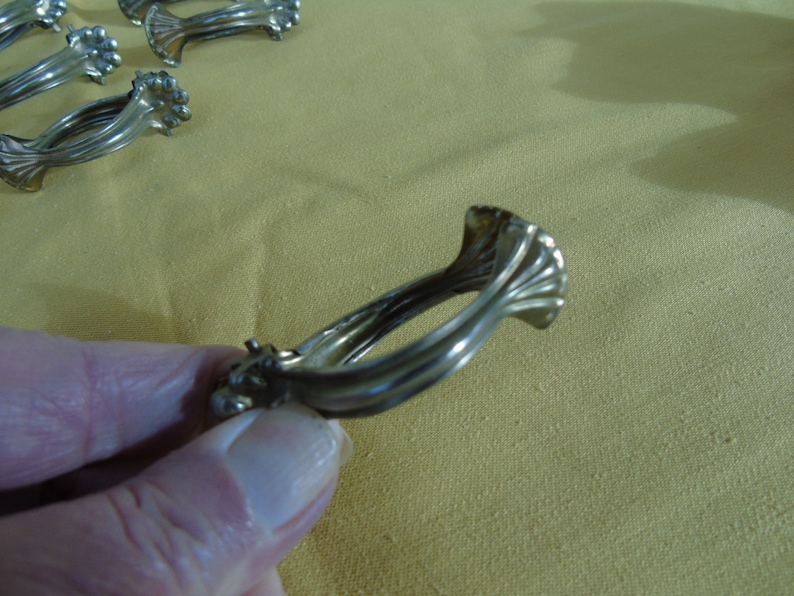 1219 French antique large size set of 10 ormolu pressed bronze curtain rings with clips.