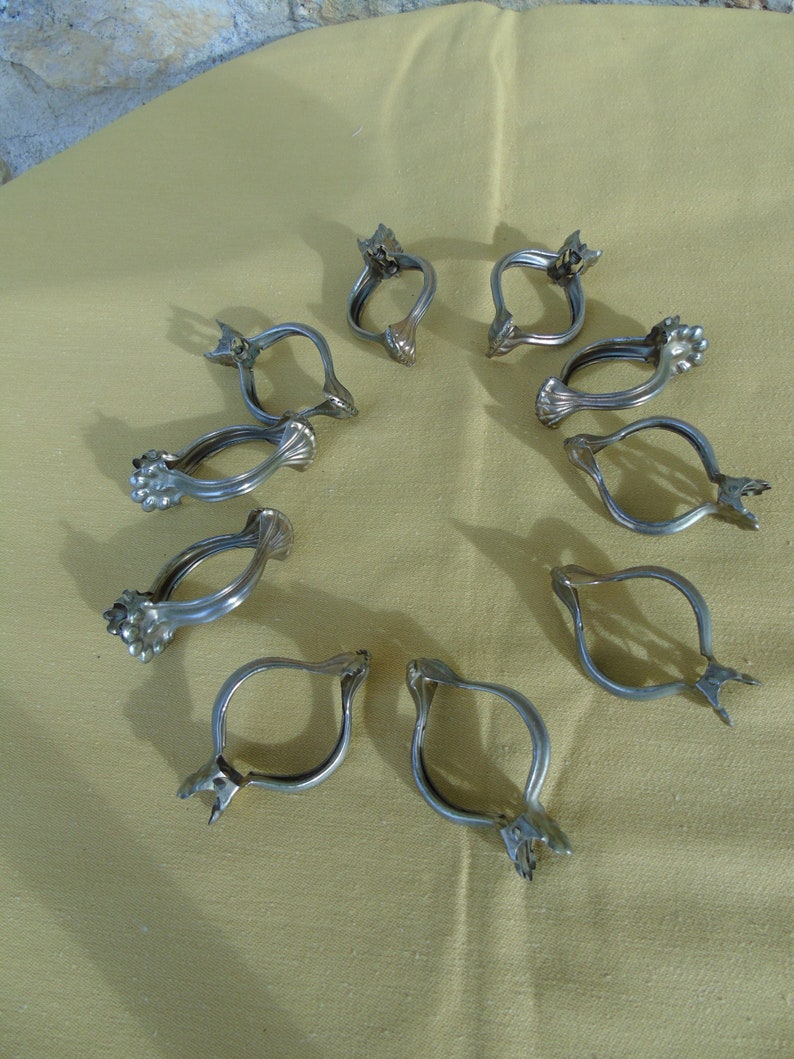 1219 French antique large size set of 10 ormolu pressed bronze curtain rings with clips.